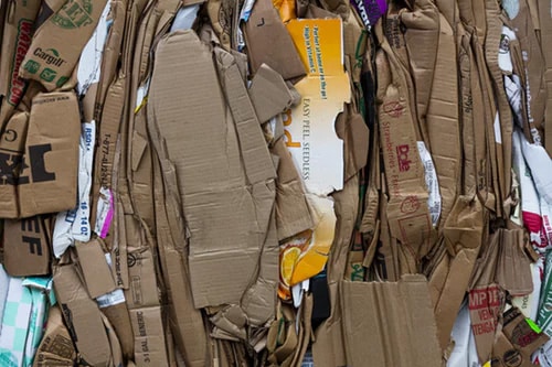 Compressed corrugated cardboard boxes compressed for recycling